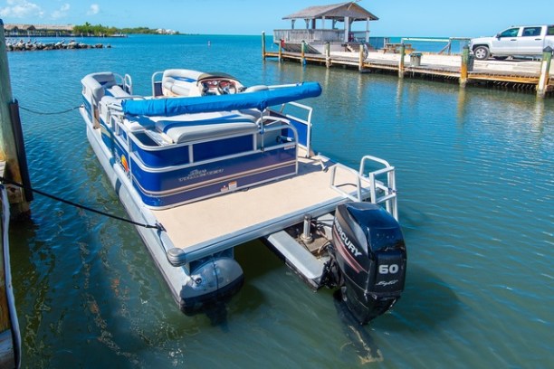 a boat that is sitting on a dock next to a body of water